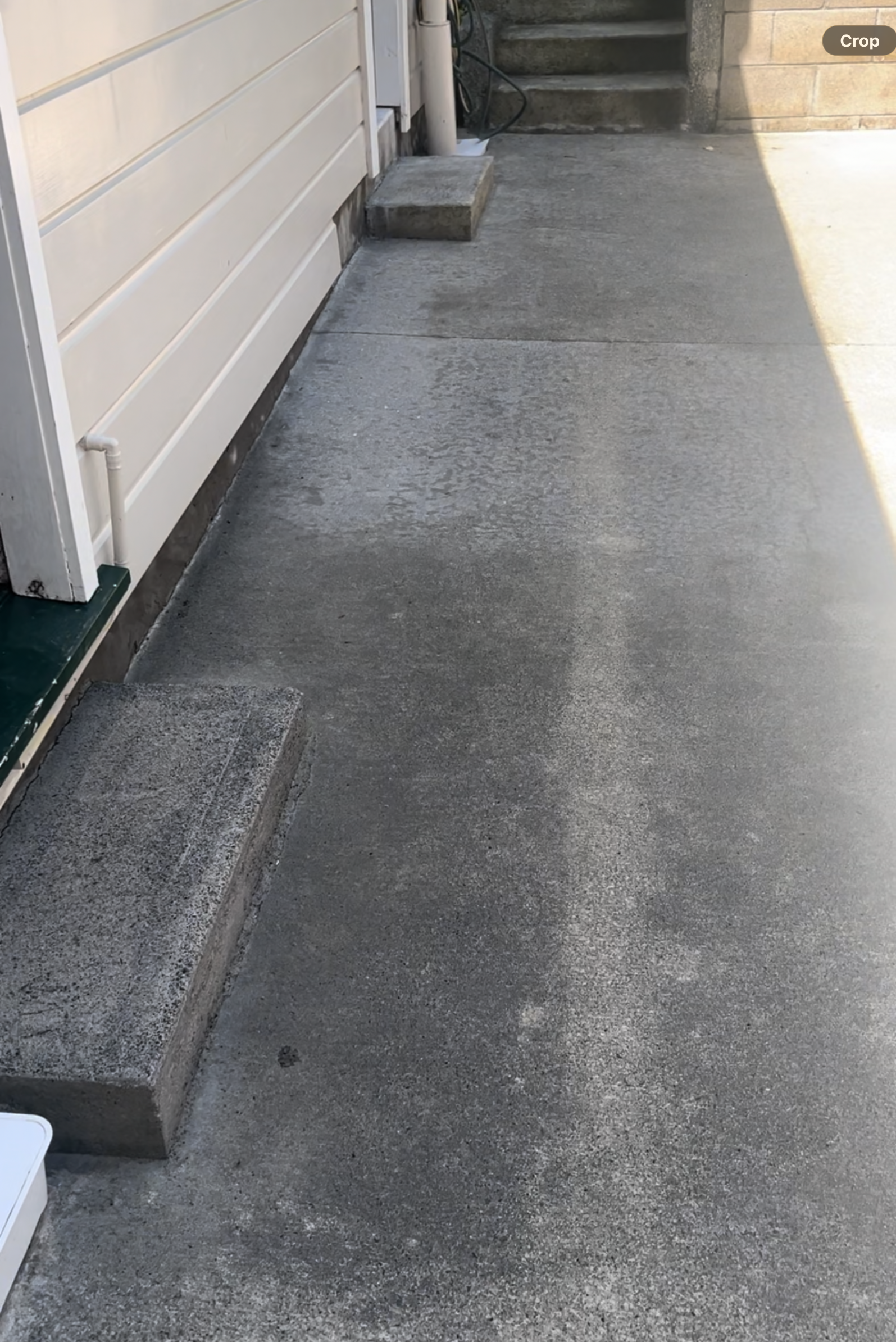 Clean grey concrete path after high-pressure cleaning